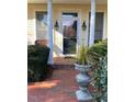 Inviting front porch with brick walkway and decorative plants at 28 W Madison, Pittsboro, NC 27312