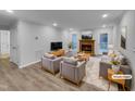 Bright living room with hardwood floors, fireplace, and ample seating at 2836 Thurrock Dr, Apex, NC 27539
