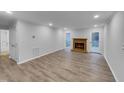 Spacious living room with wood-burning fireplace and natural light at 2836 Thurrock Dr, Apex, NC 27539