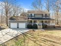 Charming two-story home with large front porch and a two-car garage at 4051 Silk Hope Gum Springs Rd, Pittsboro, NC 27312