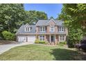 Traditional brick home with manicured lawn, two-car garage, mature landscaping, and inviting curb appeal at 407 Crickentree Dr, Cary, NC 27518