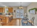Eat-in kitchen, with breakfast bar and dining table, leads to french doors and backyard at 505 Wild Goose Ln, Creedmoor, NC 27522