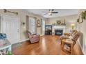 Cozy living room with hardwood floors, a fireplace, and comfortable seating at 505 Wild Goose Ln, Creedmoor, NC 27522