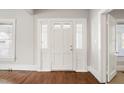 Bright entryway featuring a classic door with sidelights and stylish trim, leading to a warm interior at 512 S Mebane St, Burlington, NC 27215