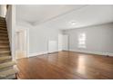 Spacious living room with hardwood floors, neutral walls, and natural light streaming through the windows at 512 S Mebane St, Burlington, NC 27215