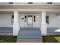 Inviting front porch with classic columns, freshly painted, and a glimpse of the neighborhood charm at 512 S Mebane St, Burlington, NC 27215