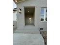 Close up of gray brick entrance with white front door and brick steps at 5705 Flowery Meadow Ct, Wake Forest, NC 27587