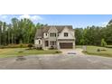 Charming exterior of a two-story home featuring a well-manicured lawn and attractive facade with gray and white accents at 5705 Flowery Meadow Ct, Wake Forest, NC 27587