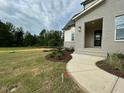 Stunning new home features light gray brick and professionally landscaped front yard at 5705 Flowery Meadow Ct, Wake Forest, NC 27587
