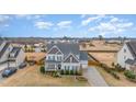 Charming two-story home with a manicured lawn, mature trees, and a long driveway, perfect for suburban living at 58 Atkins Village Ct, Fuquay Varina, NC 27526