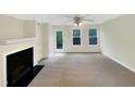 Bright living room with a fireplace, neutral decor, and lots of natural light at 5803 Osprey Cove Dr, Raleigh, NC 27604