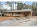 Inviting brick home featuring a cozy front porch and carport at 628 Stratford Dr, Zebulon, NC 27597