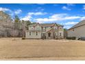 Exterior view of a two story home featuring stone accents and a spacious front lawn with mature trees at 6509 Sunset Manor Dr, Wake Forest, NC 27587