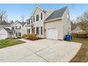 A charming home featuring an attached garage, a well-maintained driveway, and pleasing exterior at 8409 Astwell Ct, Raleigh, NC 27615