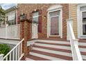 Home featuring brick front entrance, white banisters, and mahogany stained deck at 9221 Calabria Dr # 116, Raleigh, NC 27617