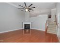 Bright living room boasts a fireplace, ceiling fan, and beautiful hardwood floors at 9221 Calabria Dr # 116, Raleigh, NC 27617