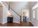 Inviting foyer with hardwood floors, staircase, and sight lines to the office and other areas at 9517 Wood River Dr, Zebulon, NC 27597