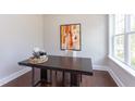 Bright office space featuring a large desk, natural light, and modern decor at 9517 Wood River Dr, Zebulon, NC 27597