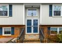 Welcoming front entrance with a brick walkway, blue front door, and symmetrical window design at 1105 Manchester Dr, Cary, NC 27511