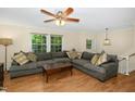 Large, open living room with a sectional sofa, hardwood floors, and natural lighting at 1105 Manchester Dr, Cary, NC 27511