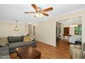 Spacious living room with wood floors, a large sectional sofa, and natural light from windows at 1105 Manchester Dr, Cary, NC 27511