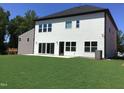 Spacious backyard featuring a walk-out patio, lush lawn, and newly planted landscaping at 1404 Malcus Ct # 56, Fuquay Varina, NC 27526