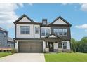 Attractive two-story home showcasing a covered entry and spacious driveway at 1404 Malcus Ct # 56, Fuquay Varina, NC 27526