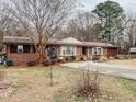 Beautiful single-story brick home featuring a well-manicured front yard at 1413 Bud Hawkins Rd, Dunn, NC 28334