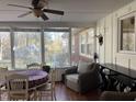 Bright sunroom with hardwood floors, a dining table, wicker chair, and large windows offering a backyard view at 1413 Bud Hawkins Rd, Dunn, NC 28334