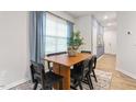 Inviting dining area with modern table and chairs, abundant natural light, and a view to the entryway at 1910 Frost Dr, Haw River, NC 27258