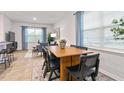 Inviting dining area with modern table and chairs, abundant natural light, and an open view to the living room at 1910 Frost Dr, Haw River, NC 27258