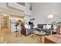 Open-concept living room with modern decor, sleek furniture and a breakfast bar to the kitchen at 200 S Dawson St # 103, Raleigh, NC 27601