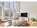 Inviting living room featuring high ceilings, large windows and comfortable seating arrangement at 200 S Dawson St # 103, Raleigh, NC 27601