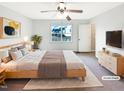 Comfortable bedroom featuring a ceiling fan, large window, and neutral decor at 2042 Compacta Dr, Wendell, NC 27591