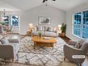 Bright living room with vaulted ceilings, hardwood floors, and large windows at 2042 Compacta Dr, Wendell, NC 27591