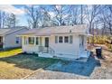 Charming single-story home with white siding, black trim, and well-maintained front yard at 210 Monk Rd, Durham, NC 27704