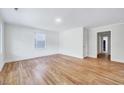 Spacious living room featuring pristine walls and gleaming hardwood flooring at 210 Monk Rd, Durham, NC 27704