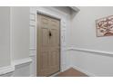 Neutral-colored front door, showcasing the unit number and classic hardware at 232 Eyam Hall Ln, Apex, NC 27502