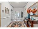 Elegant lobby with a decorative rug, console table, and a large mirror, creating a welcoming entrance at 232 Eyam Hall Ln, Apex, NC 27502