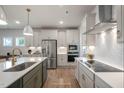 Modern kitchen with stainless steel appliances, white cabinets, and a stylish island at 26 Kitty Branch Way, Smithfield, NC 27577