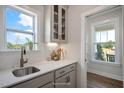 Bright kitchen detail with quartz countertops, stylish sink, and ample cabinet space at 26 Kitty Branch Way, Smithfield, NC 27577