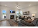 Cozy living room featuring a fireplace, plush sofas, and abundant natural light at 26 Kitty Branch Way, Smithfield, NC 27577