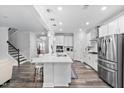 Bright, open kitchen with white cabinets, stainless steel appliances, and a large center island with bar seating at 2612 Nordmann Fir Rd, Raleigh, NC 27616