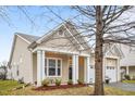 Charming single-story home with a welcoming front porch, neutral siding, and a convenient two-car garage at 2815 Mebane Ln, Durham, NC 27703
