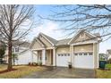 Charming single-story home features a two-car garage, front porch with columns, and well-maintained landscaping at 2815 Mebane Ln, Durham, NC 27703