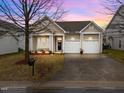 Charming single-story home features a two-car garage, front porch with columns, and well-maintained landscaping at 2815 Mebane Ln, Durham, NC 27703