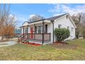 Charming single-story home featuring a welcoming porch and well-maintained lawn at 318 Fulton St, Burlington, NC 27217