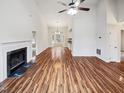 Spacious and bright living room featuring wood floors and fireplace, open floor plan with dining area at 4205 Rockside Hills Dr, Raleigh, NC 27603