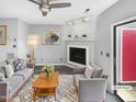 Cozy living room featuring stylish furniture, a fireplace, and a ceiling fan at 4213 Sunscape Ln, Raleigh, NC 27613