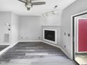 Bright living room with a fireplace and modern track lighting; perfect for relaxing or entertaining at 4213 Sunscape Ln, Raleigh, NC 27613